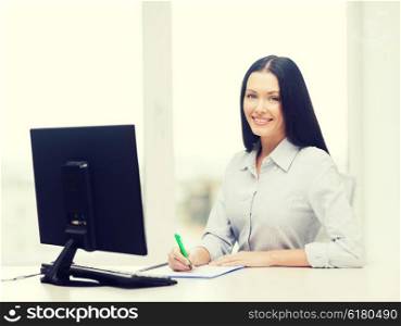 education, school, business and technology concept - smiling businesswoman or student studying