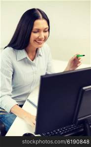 education, school, business and technology concept - smiling businesswoman or student studying