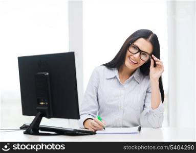 education, school, business and technology concept - smiling businesswoman or student wearing black eyeglasses