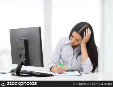education, school, business and technology concept - tired businesswoman or student studying