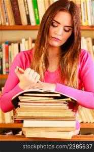 Education school concept. Intelligent female student fashion long hair girl in college library with pen