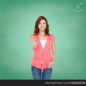 education, school, gesture and people concept - smiling teenage girl in casual clothes showing thumbs up over green board background