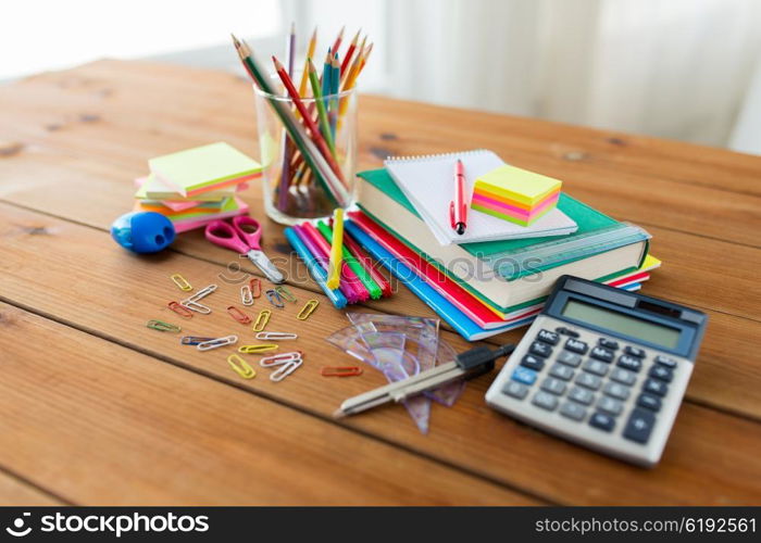 education, school supplies, art, creativity and object concept - close up of stationery on wooden table