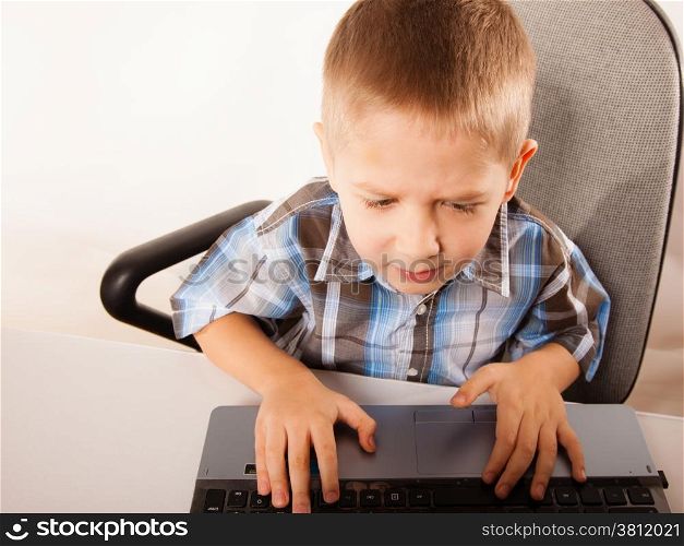Education, school, technology and internet concept - little student boy with laptop pc computer