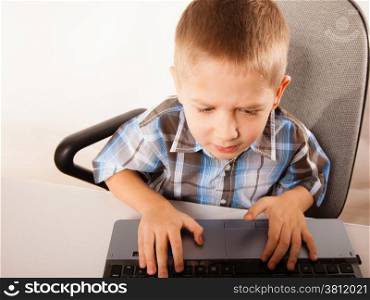 Education, school, technology and internet concept - little student boy with laptop pc computer
