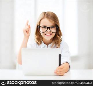 education, school, technology and internet concept - little student girl in black eyeglasses with tablet pc computer and finger up at school