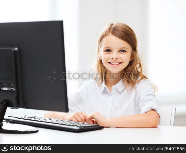 education, school, technology and internet concept - little student girl with computer at school