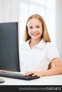 education, school, technology and internet concept - little student girl with computer at school