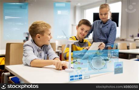 education, science, technology, children and people concept - group of smiling kids or students with tablet pc computer programming electric windmill toy at robotics school lesson. kids with tablet pc programming at robotics school