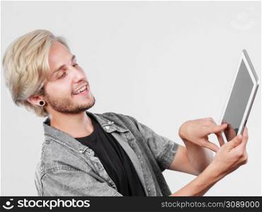 Education social media. Modern technology internet concept. Stylish handsome young man using tablet computer. Trendy young man using tablet computer