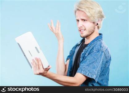 Education social media. Modern technology internet concept. Stylish handsome young man using tablet computer, thinking. Trendy young man using tablet thinking