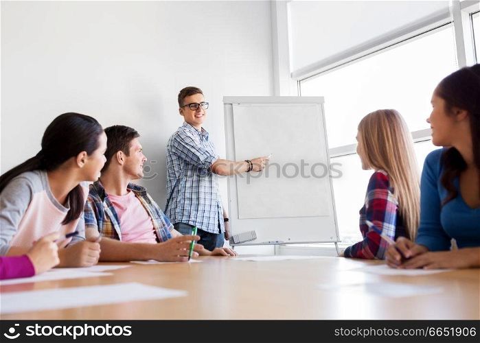 education, teamwork and people concept - group of high school students with flip chart. group of high school students with flip chart