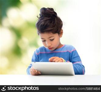 education, technology and children concept - little student girl with tablet pc over green background
