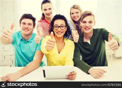education, technology and college concept - five smiling students with tablet pc computer at school and showing thumbs up