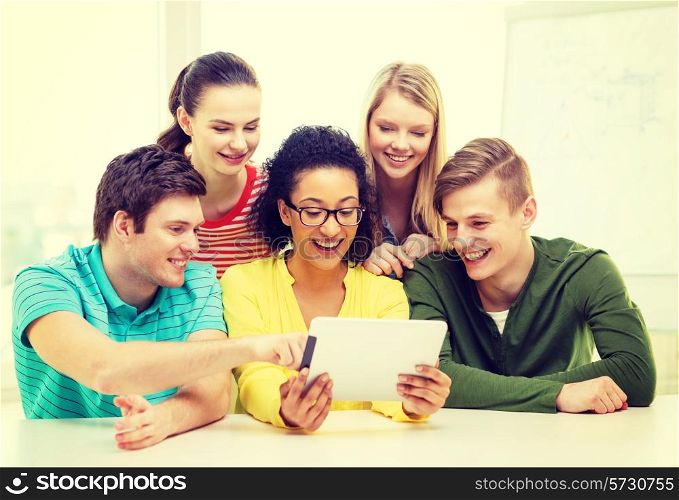 education, technology and college concept - five smiling students with tablet pc computer at school