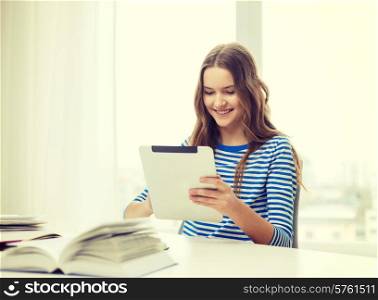 education, technology and home concept - happy smiling student girl with tablet pc computer and books at home