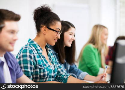 education, technology and internet - african student with computer studying at school