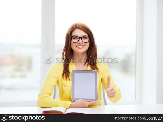 education, technology and internet concept - smiling student girl in eyeglasses with tablet pc at school showing thumbs up