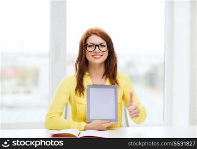 education, technology and internet concept - smiling student girl in eyeglasses with tablet pc at school showing thumbs up