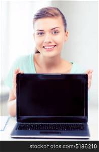education, technology and internet concept - smiling student girl with laptop. smiling student girl with laptop