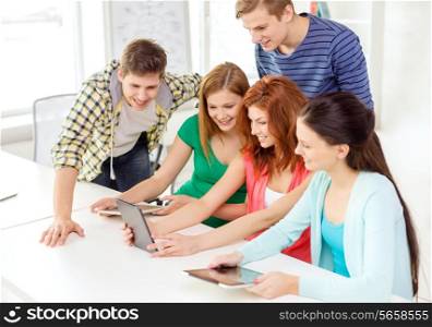 education, technology and internet concept - smiling students with tablet pc computer at school