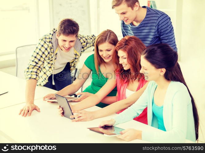 education, technology and internet concept - smiling students with tablet pc computer at school