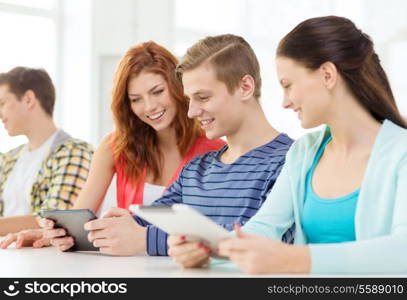 education, technology and internet concept - smiling students with tablet pc computers at school