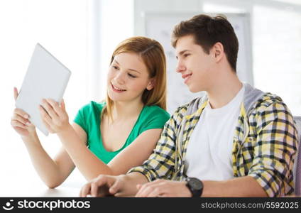 education, technology and internet concept - smiling students with tablet pc computers at school