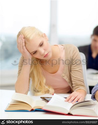 education, technology and internet concept - tired teenage girl student with tablet pc and books preparing for exam