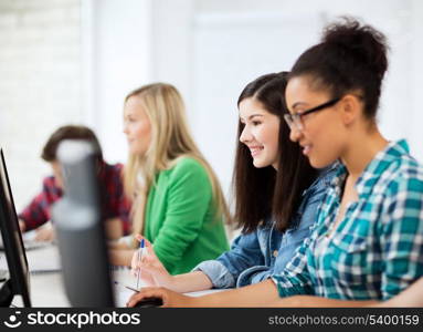 education, technology and internet - students with computers studying at school