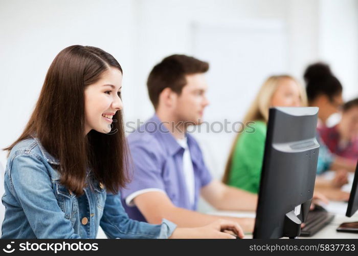 education, technology and internet - students with computers studying at school