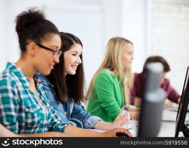 education, technology and internet - students with computers studying at school