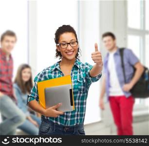 education, technology and people concept - smiling female african american student in eyeglasses with folders and tablet pc at school