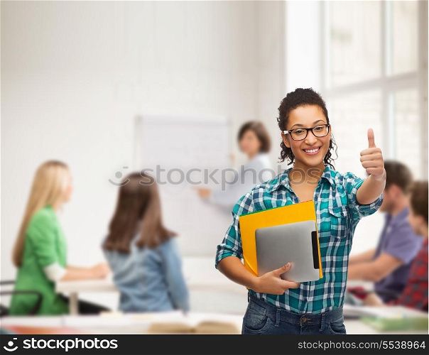 education, technology and people concept - smiling female african american student in eyeglasses with folders and tablet pc at school