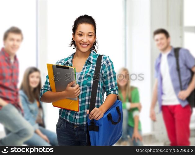 education, technology and people concept - smiling female african american student with folders, bag and tablet pc