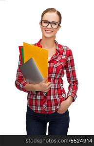 education, technology and people concept - smiling female student in eyeglasses with folders and tablet pc