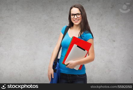 education, technology and people concept - smiling student wearing black eyeglasses with bag, folders and tablet pc computer standing