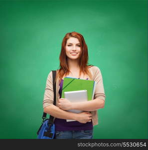 education, technology and people concept - smiling student with bag, folders and tablet pc computer standing