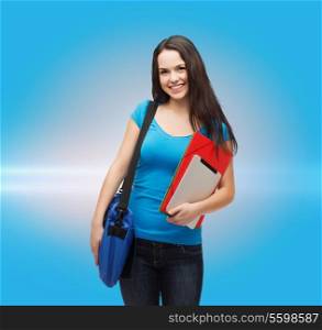 education, technology and people concept - smiling student with bag, folders and tablet pc computer standing