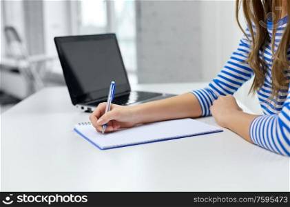 education, technology and people concept - student girl with exercise book, pen and laptop computer. student girl with exercise book, pen and laptop