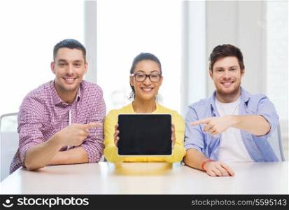 education, technology, business, startup and office concept - three smiling colleagues showing tablet pc blank screen