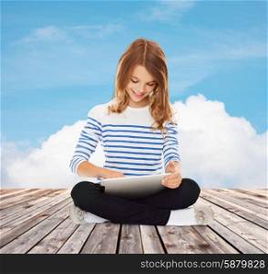 education, technology, childhood and people concept - happy little student girl with tablet pc over blue sky and cloud background