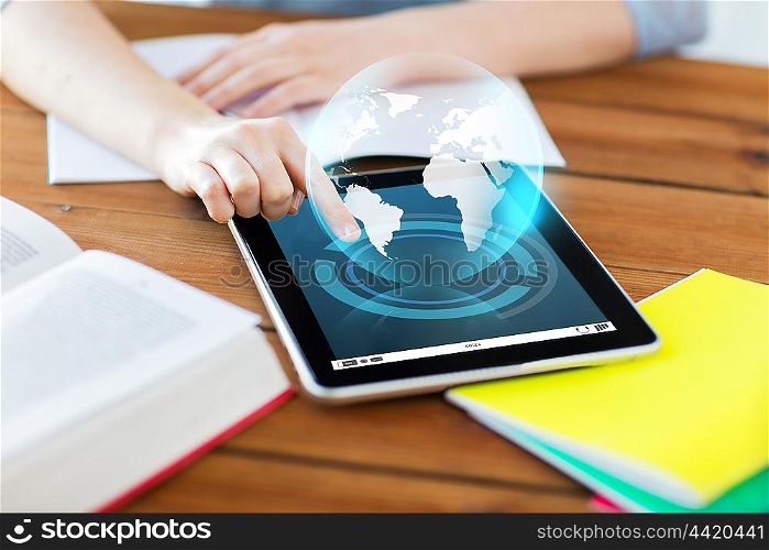 education, technology, communication and international concept - close up of student woman with earth globe hologram over tablet pc computer and notebook at home