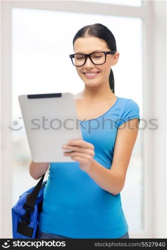 education, technology, communication and school concept - smiling female student in eyeglasses with tablet pc and bag at school