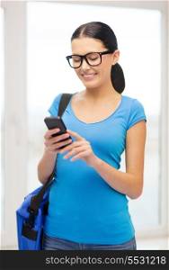 education, technology, communication and school concept - smiling female student in eyeglasses with smartphone and bag at school