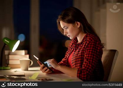 education, technology, freelance, overwork and people concept - woman or student girl with tablet pc computer at night home. student girl or woman with tablet pc at night home