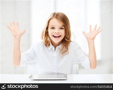 education, technology, internet and school concept - laughing little student girl with tablet pc computer and hands up at school