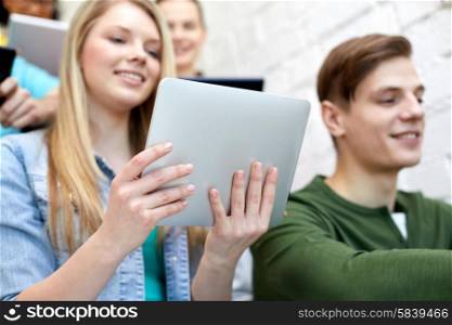 education, technology, people and internet concept - close up of smiling students with tablet pc computers at school