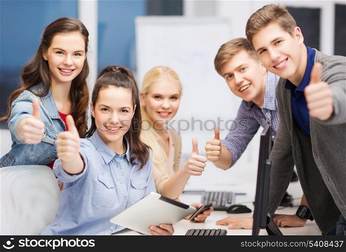 education, techology and internet concept - group of smiling students with computer monitor and tablet pc