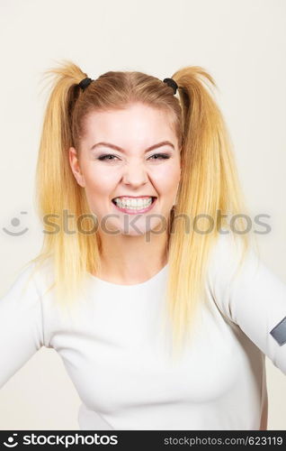 Education, teenage adolescence, happiness concept. Happy blonde teenager student girl with ponytails. Happy blonde teenager girl with ponytails